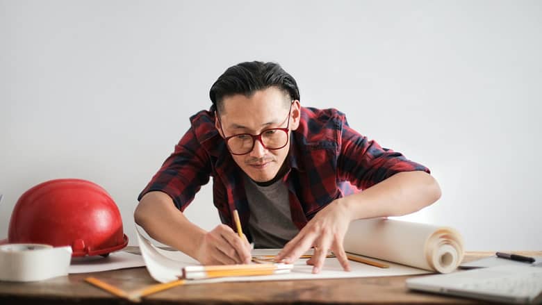 man drawing with a ruler